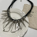 Leather necklace with round beads, winding tassel, and point rivet details in casual style