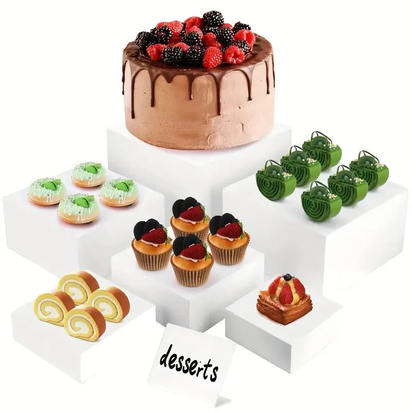 White plastic modular dessert display stand with six interlocking cube pieces arranged in a tiered configuration.