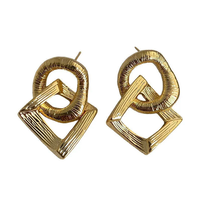 Copper geometric circle drop earrings with 3.4cm pendant in gold and silver finishes.