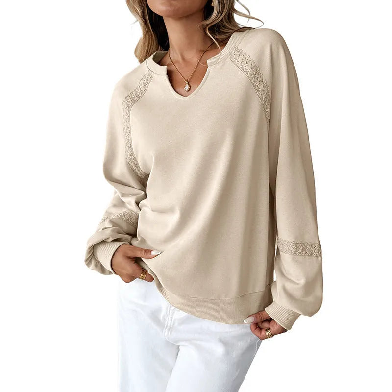 Women's loose fit long sleeve sweater with lace detail on half-open collar, shown in a solid colour.