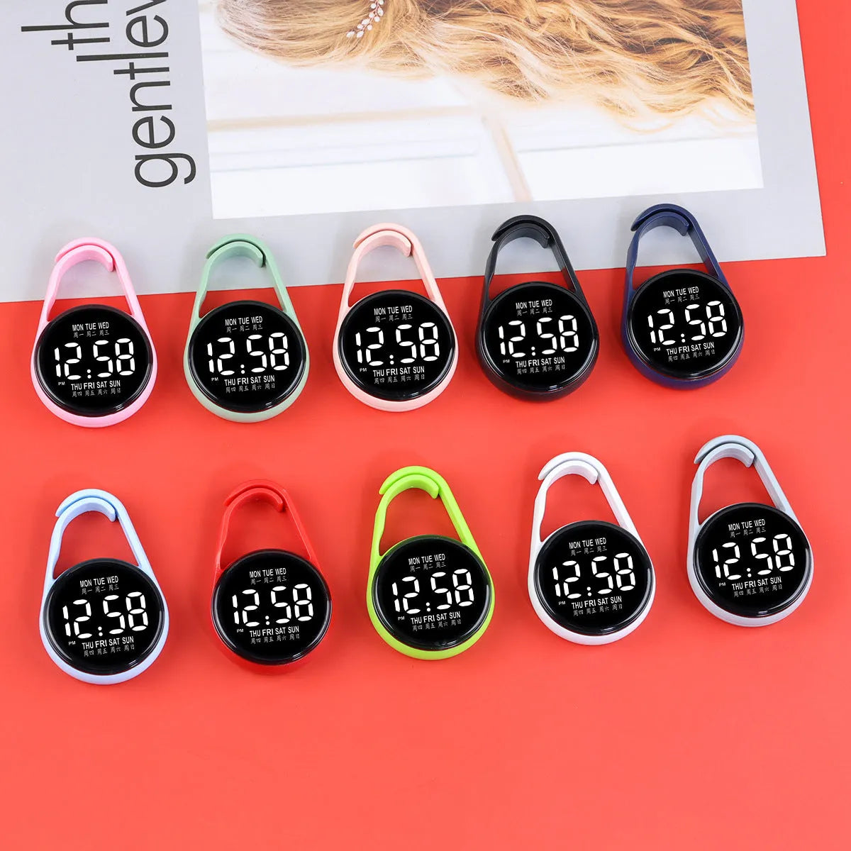 Mini digital electronic watch with luminous week display on a plastic strap, shown in multiple colour options.