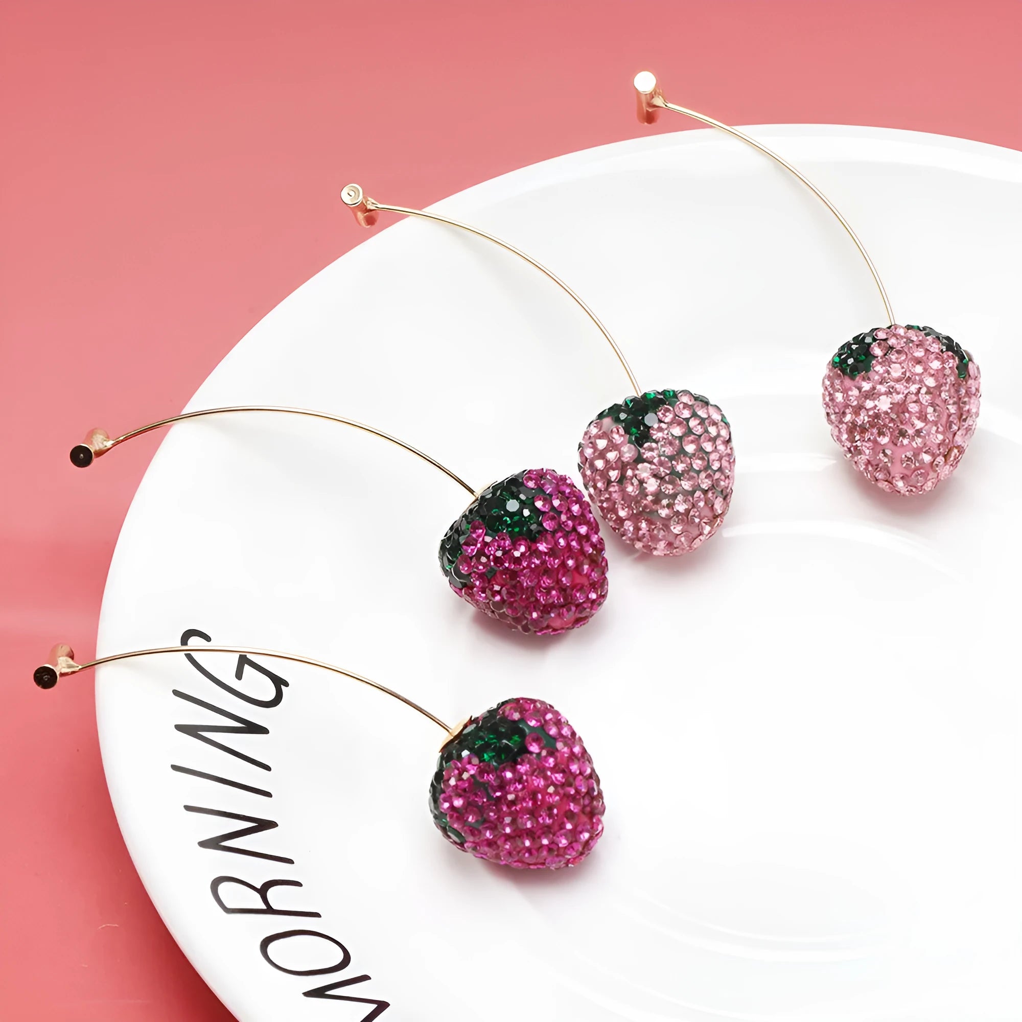 Geometric zinc alloy stud earrings with a strawberry design in red spot drill finish.