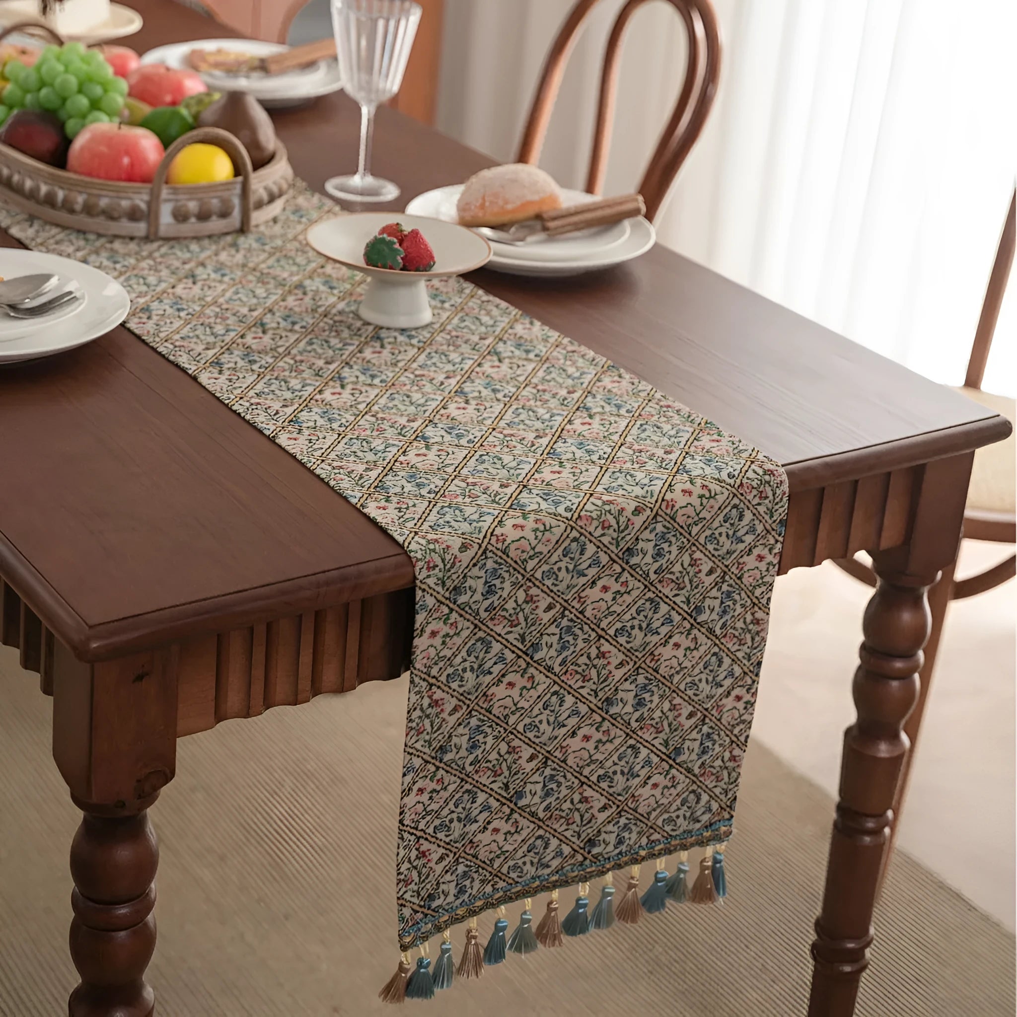 Dark blue striped Nordic style table runner with bouquet tassel decoration laid flat on a table.