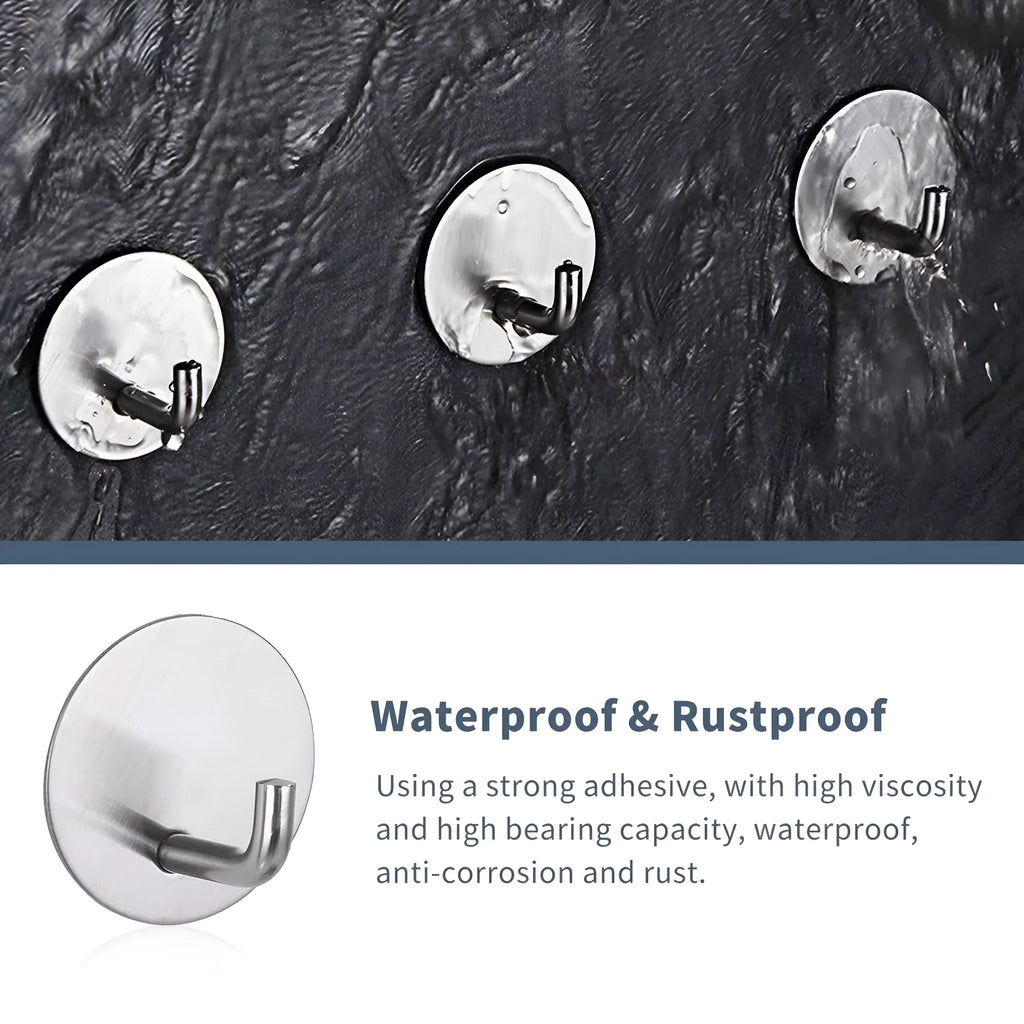 Stainless steel self-adhesive wall hook in black and polished finishes, shown with a towel hanging from it.