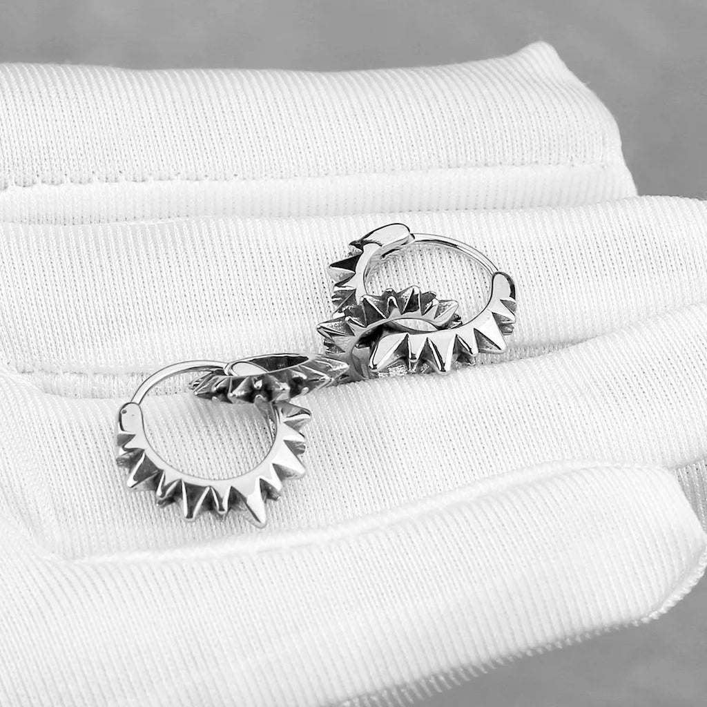 A pair of polished stainless steel round hoop earrings in a steel colour with a simple, retro design.