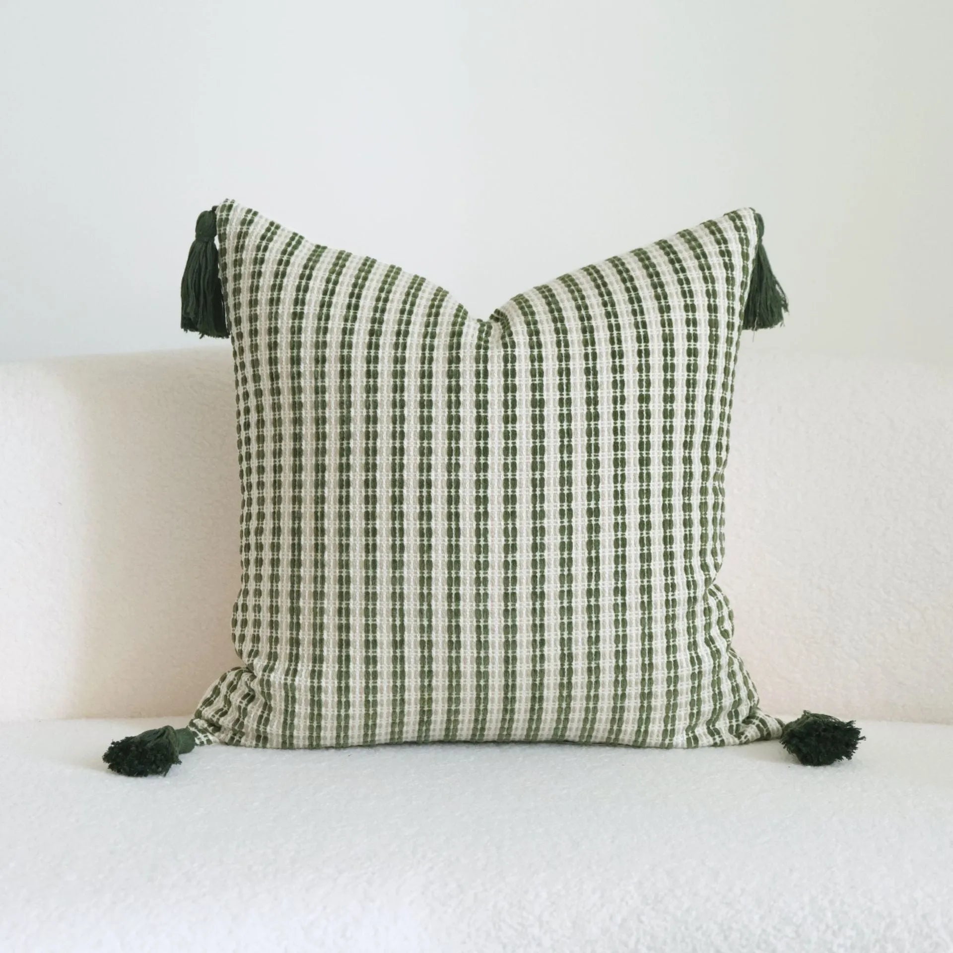 Green cotton and linen hotel sample pillow with botanical pattern and tassel trim, shown with separate pillow core.