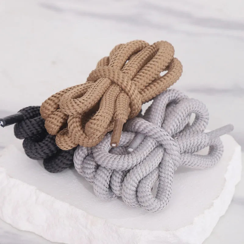 Round 1.0cm wide shoelace adapters in multiple colours including black, pink, blue, and grey on a white background.