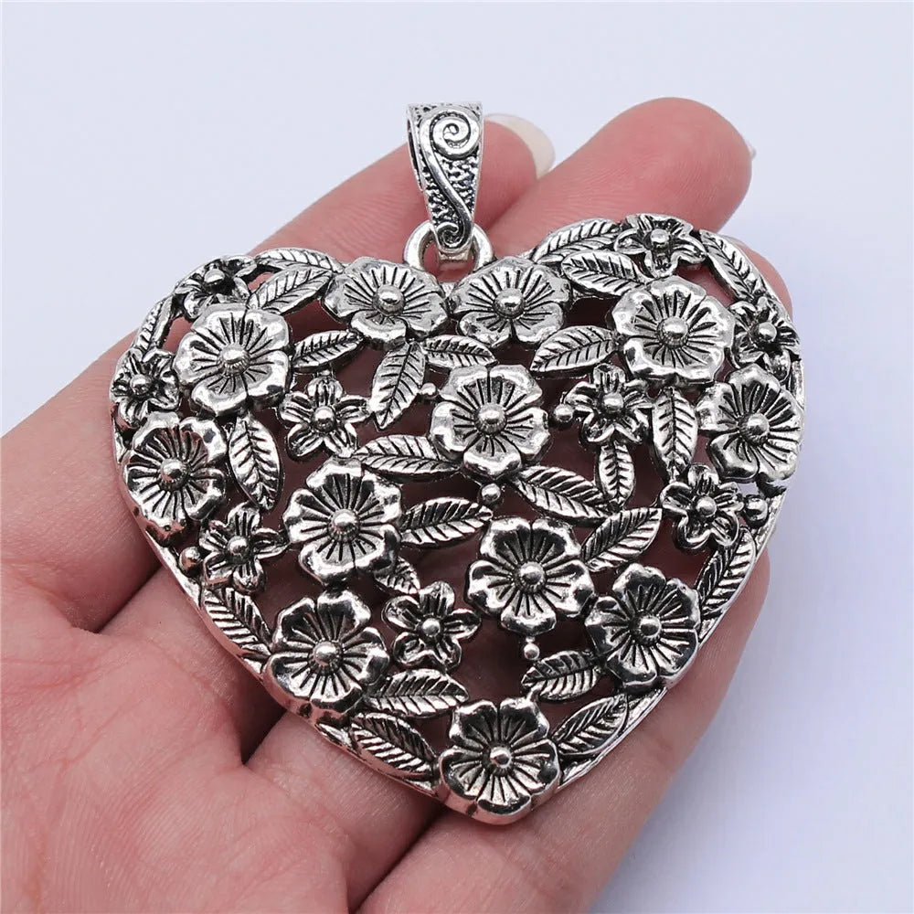 Hollow flower love pendant in ancient silver alloy finish, 67x58mm, on white background