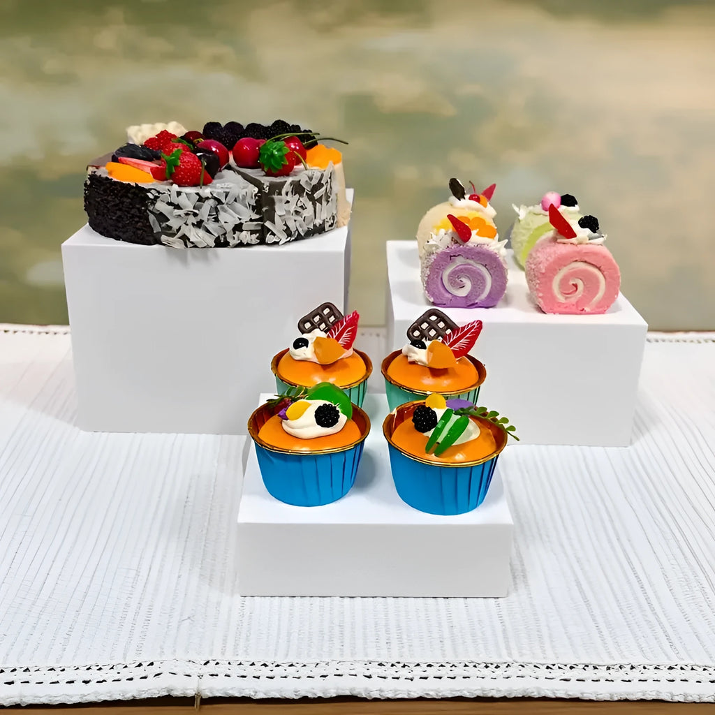 White plastic modular dessert display stand with six interlocking cube pieces arranged in a tiered configuration.