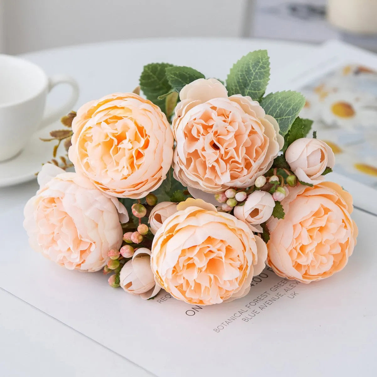 Artificial silk peony bouquet in a champagne colour for home or wedding decoration.