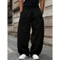 Man wearing dark grey high waist straight leg cropped casual trousers with an elasticated waistband.
