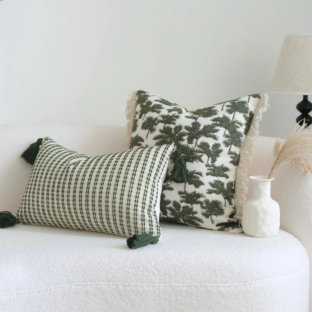 Green cotton and linen hotel sample pillow with botanical pattern and tassel trim, shown with separate pillow core.
