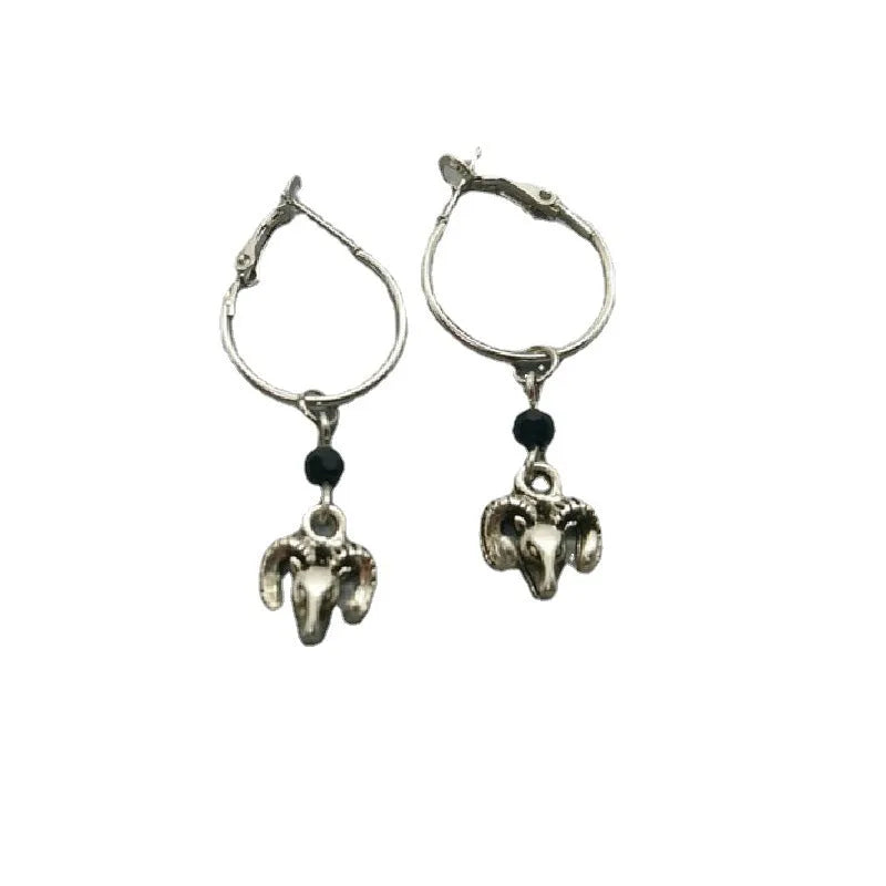 A pair of silver round ring earrings with a Tibetan antelope design.