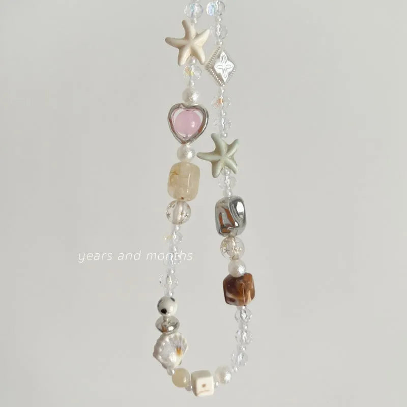Island Sweetheart bohemian beaded alloy mobile phone charm on pastel background