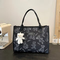 Women's printed canvas tote bag with large capacity, shown in black and white colour options with optional pendant