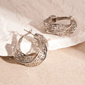 Women's geometric hollow stud earrings with twisted round design in silver or gold finish