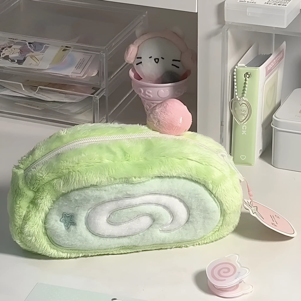 Honeydew Roll plush velvet pencil case with Swiss roll cake design on a desk.