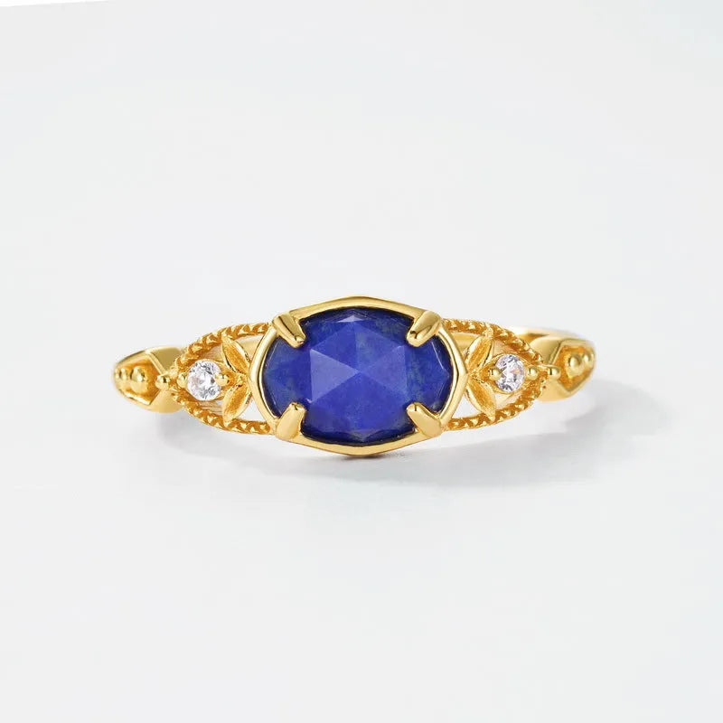 Silver ellipse ring with deep blue lapis lazuli stone in a geometric Japanese style design.