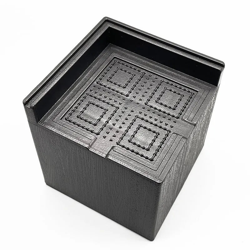 Four black thickened plastic bed foot mats arranged for height increasing furniture support