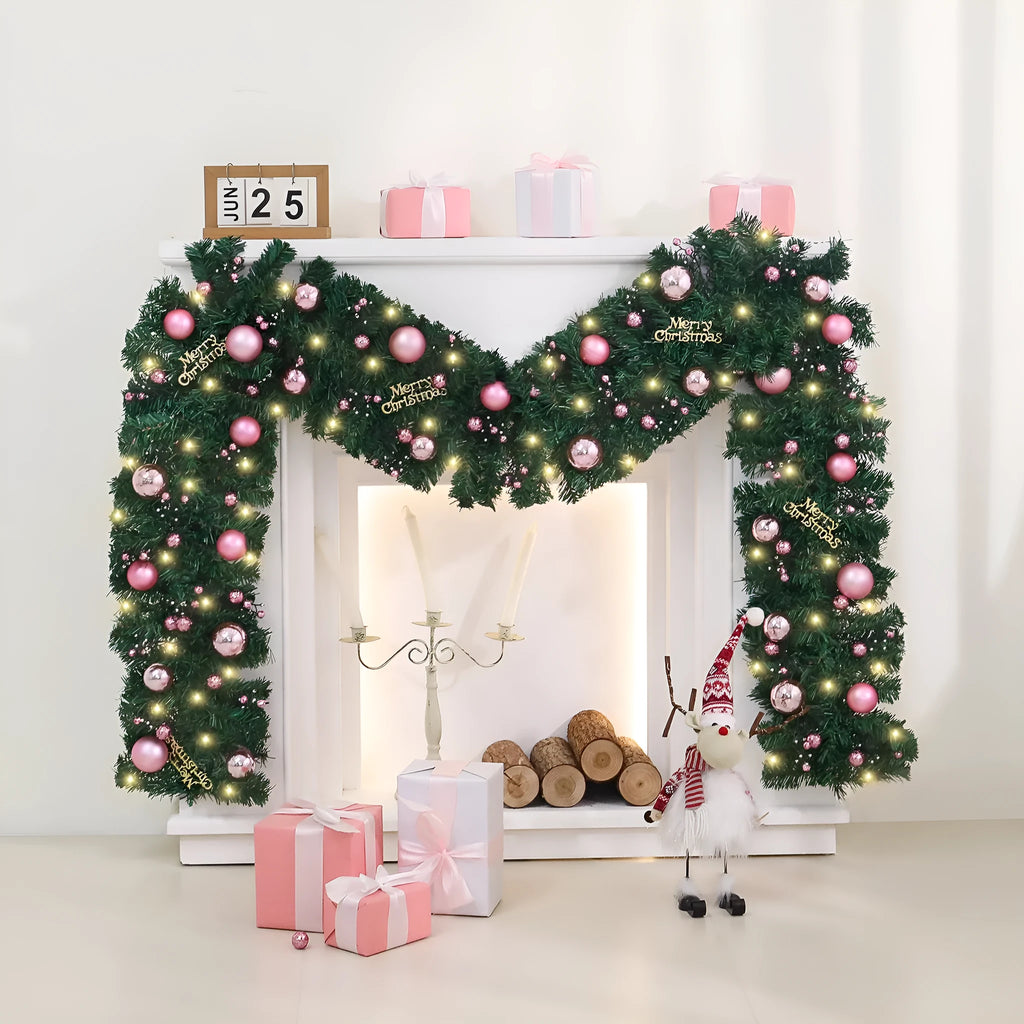Long pink rattan Christmas wreath with small fruit decoration, shown draped on a door.
