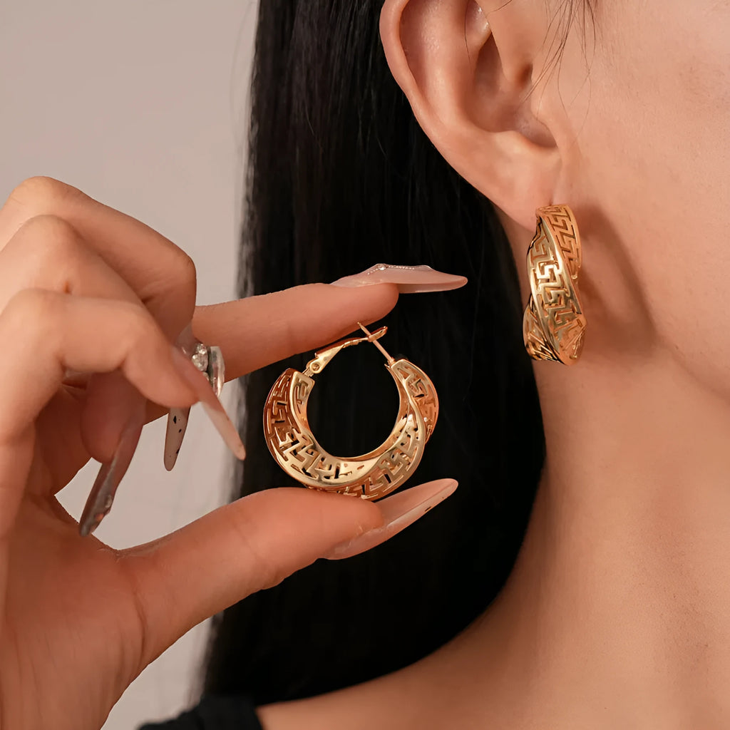 Women's geometric hollow stud earrings with twisted round design in silver or gold finish