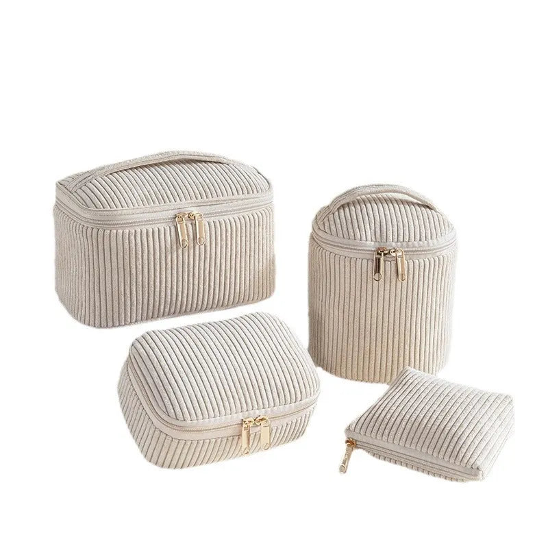 Four cube-shaped flannelette makeup bags in coordinated colours for travel organisation