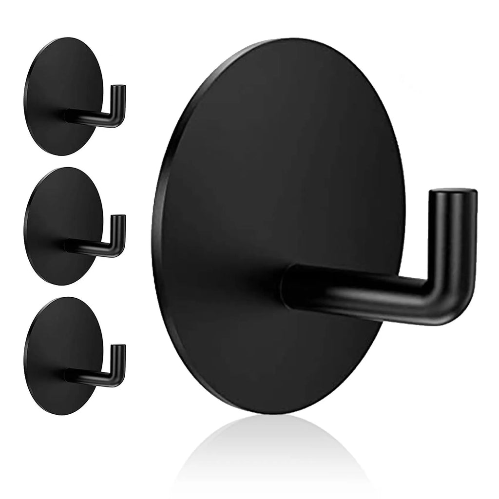 Stainless steel self-adhesive wall hook in black and polished finishes, shown with a towel hanging from it.