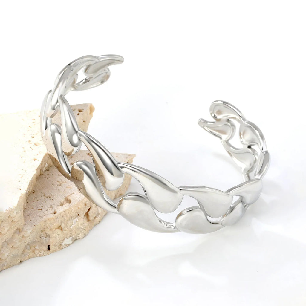 Contemporary stainless steel and alloy bracelet in European-American style on a wrist.
