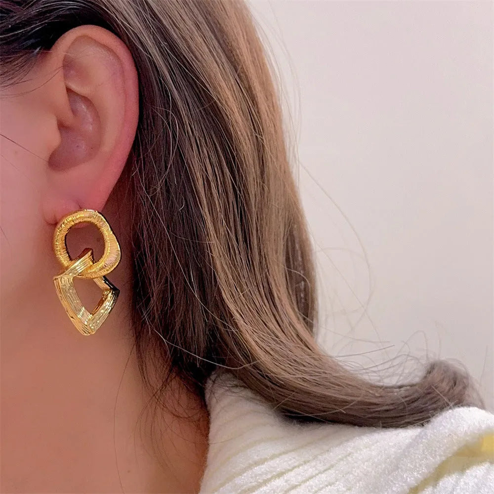 Copper geometric circle drop earrings with 3.4cm pendant in gold and silver finishes.
