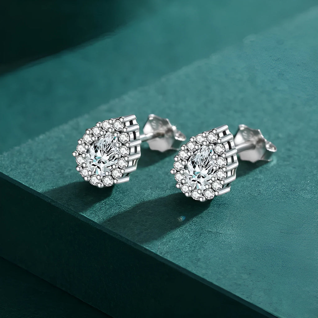 Silver waterdrop shaped ear studs with diamond-cut finish on 925 sterling silver
