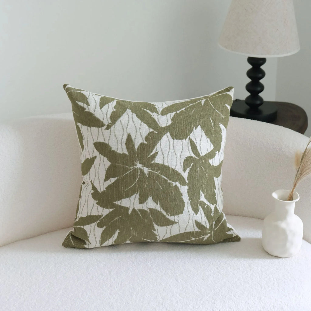 Green cotton and linen hotel sample pillow with botanical pattern and tassel trim, shown with separate pillow core.