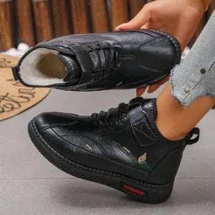 Women's black velvet plimsoll with non-slip rubber sole and hollow-out detailing