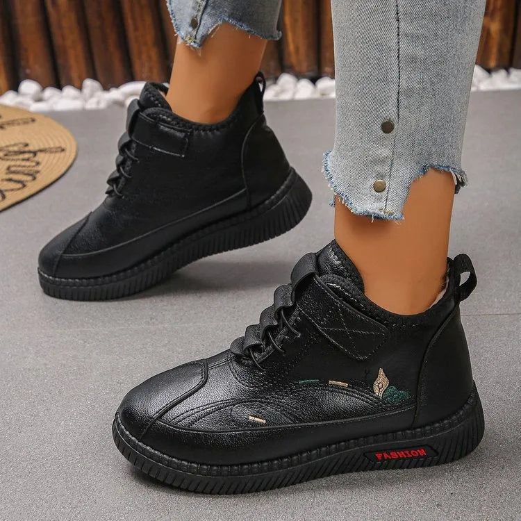 Women's black velvet plimsoll with non-slip rubber sole and hollow-out detailing