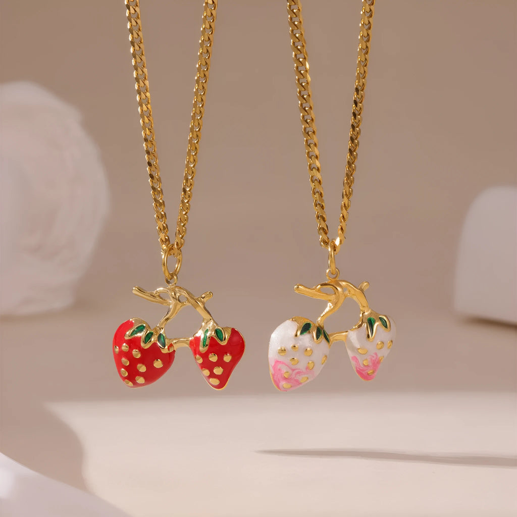 Close-up of a women's stainless steel strawberry pendant necklace on an alloy chain, showing red and white gradient colour options.