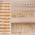 108-piece set of gold and yellow geometric round alloy pearl earrings for women on a plain background.