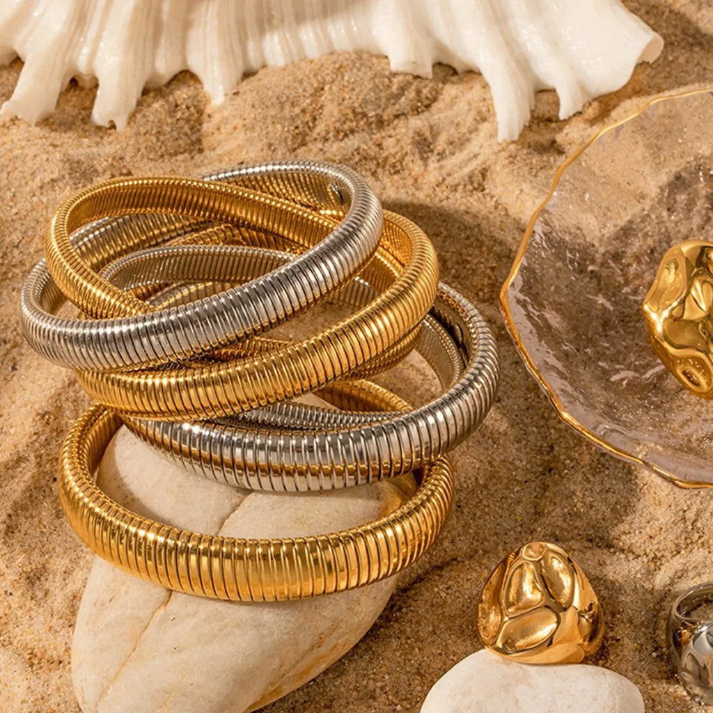 Women's vertical stripe elastic titanium steel bracelet in gold or silver finish with five width options