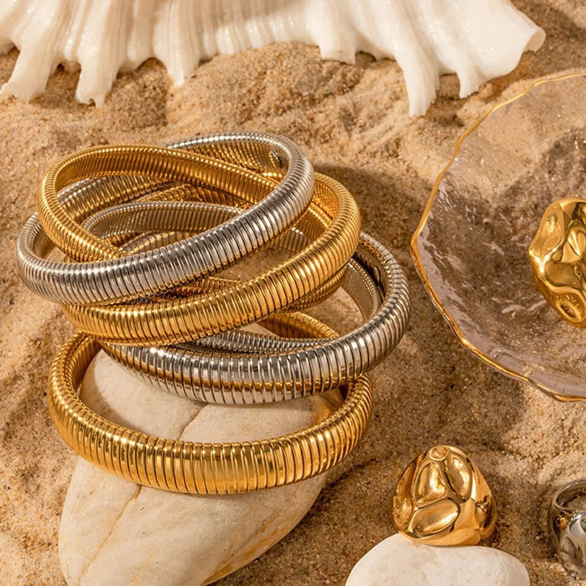 Women's vertical stripe elastic titanium steel bracelet in gold or silver finish with five width options