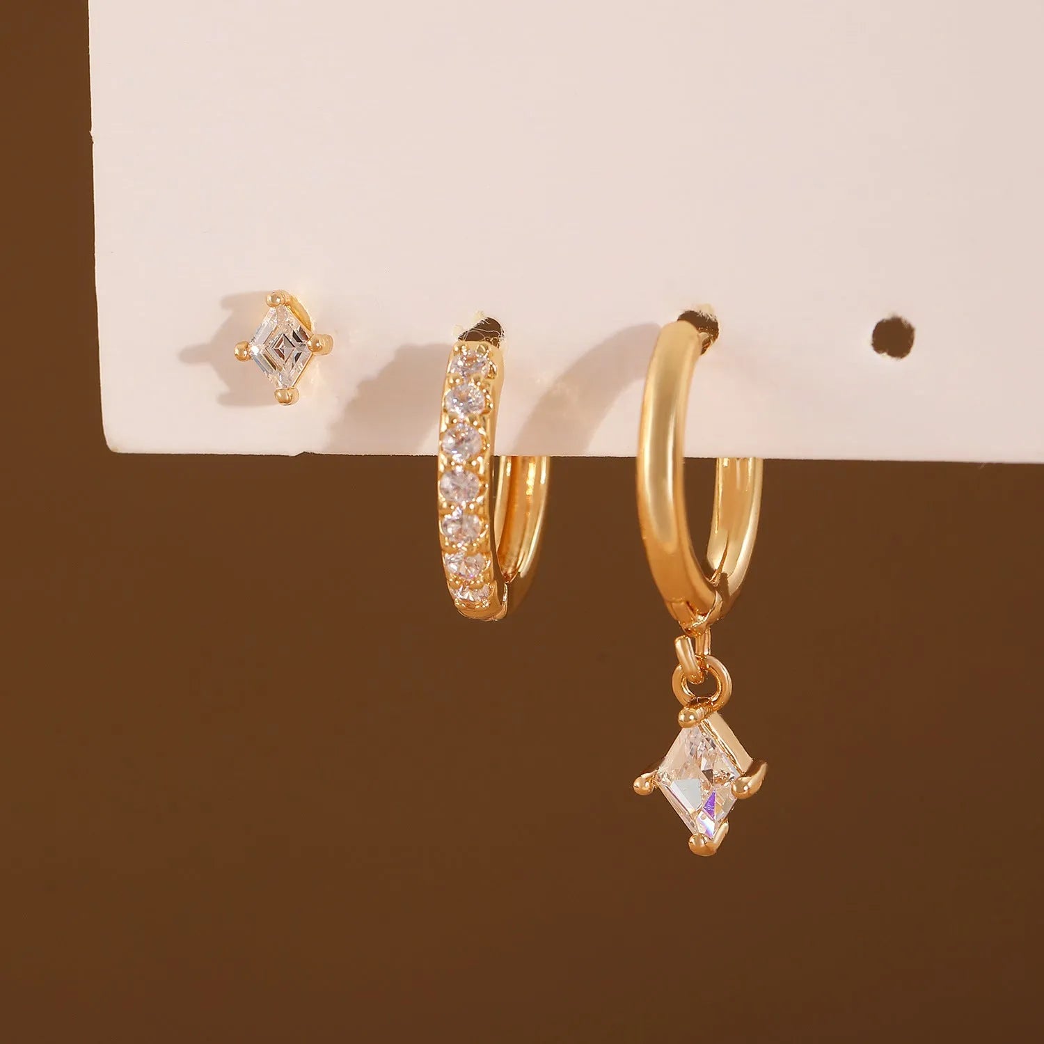 Ladies three-piece earring set with geometric designs and inlaid zircon stones in gold or white finish