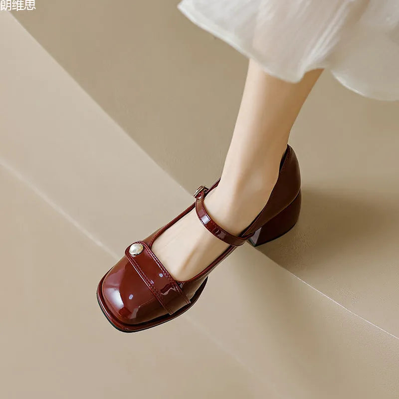 Plus size patent leather pumps with chunky block heels in apricot colour, showing square toe design and buckle fastening