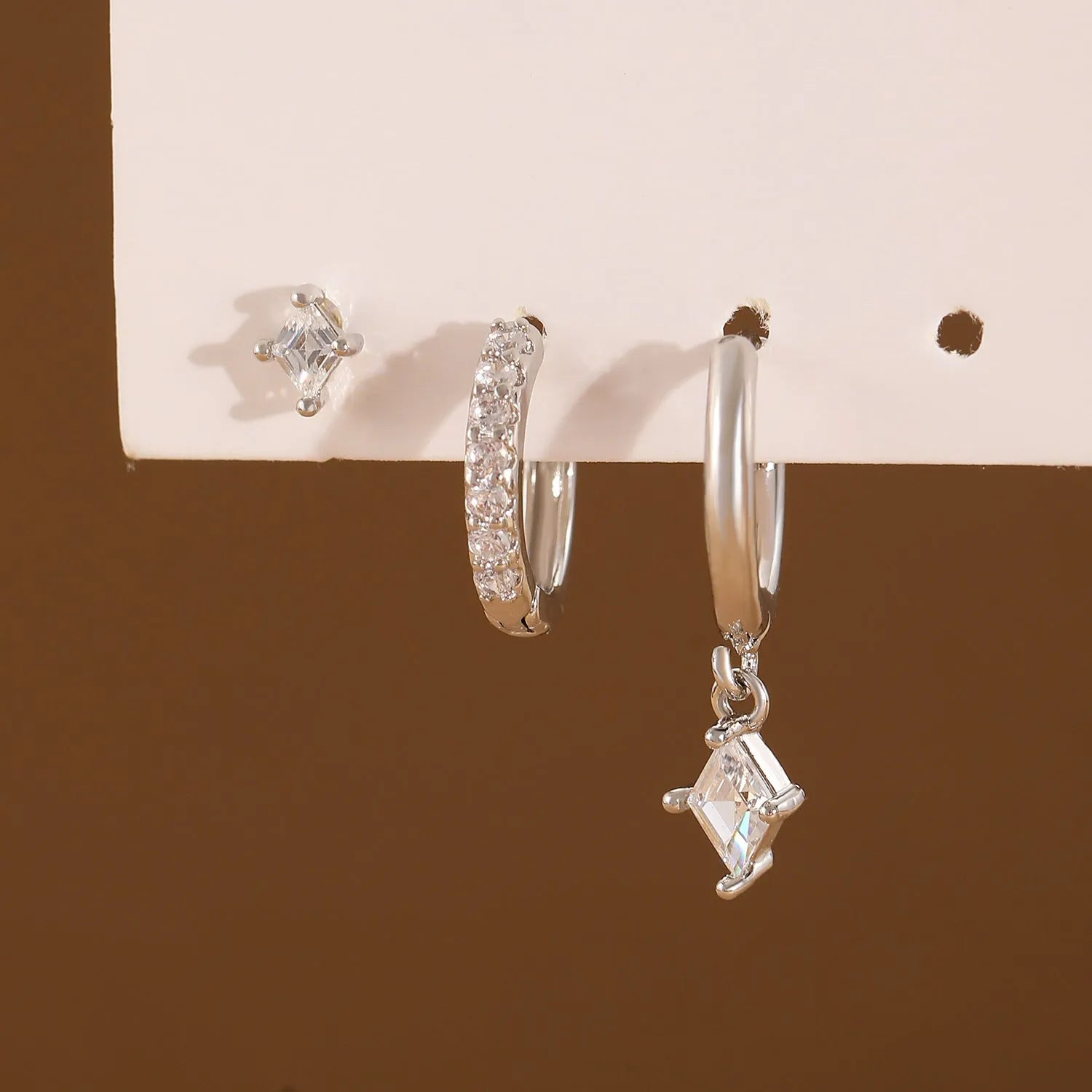 Ladies three-piece earring set with geometric designs and inlaid zircon stones in gold or white finish