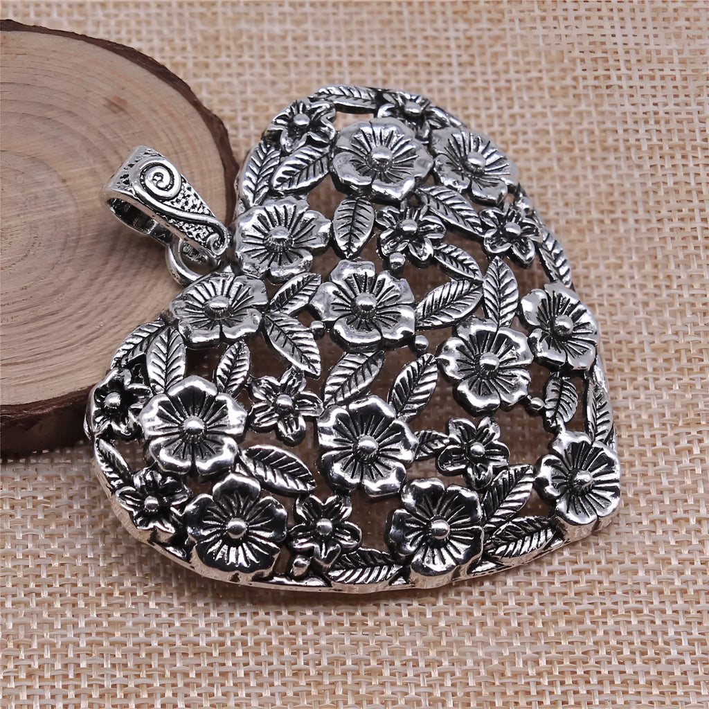 Hollow flower love pendant in ancient silver alloy finish, 67x58mm, on white background