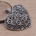 Hollow flower love pendant in ancient silver alloy finish, 67x58mm, on white background