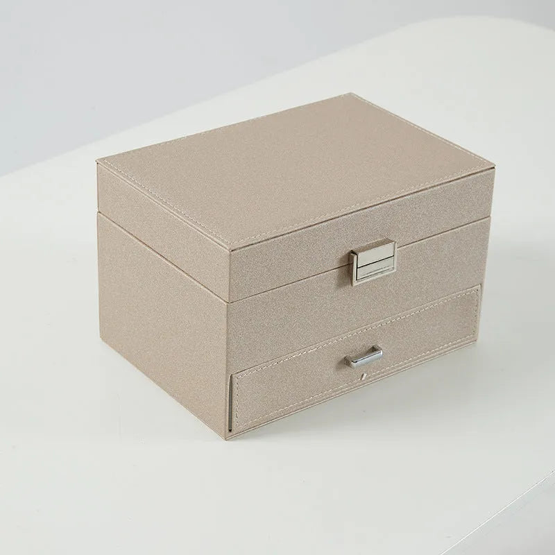 Hard PU leather jewellery storage box with velvet-lined interior compartments in beige colour.