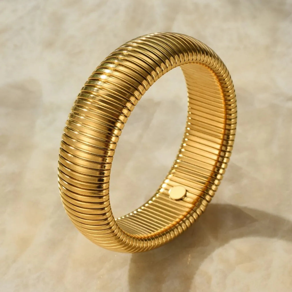 Women's vertical stripe elastic titanium steel bracelet in gold or silver finish with five width options