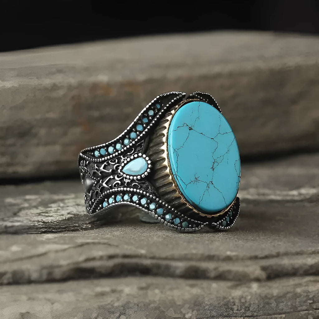 Men's turquoise and antique silver alloy ring on finger showing round band design with UK size markings