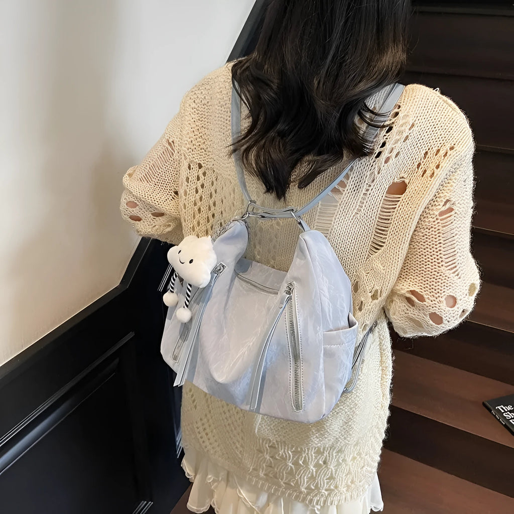 Women's soft PU backpack in blue with a matching detachable pendant for convertible carry