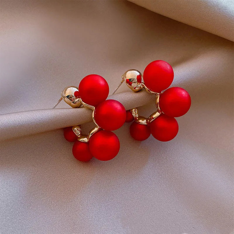 Red bell charm alloy earrings with pendant design, also available in white