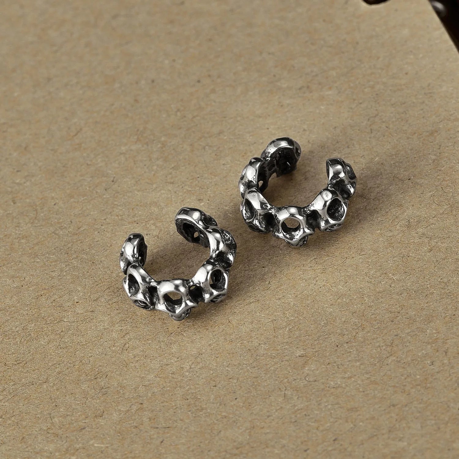 Retro hollow skull stainless steel clip-on earrings with geometric design