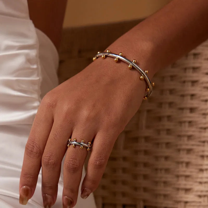 Stainless steel C-shaped bracelet with textured rivet bean beads and adjustable alloy chain