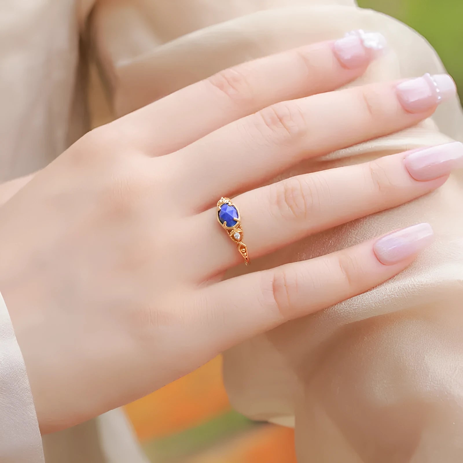 Silver ellipse ring with deep blue lapis lazuli stone in a geometric Japanese style design.